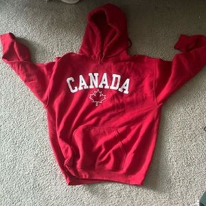 Red gildan hoodie with Canada print and leaf/